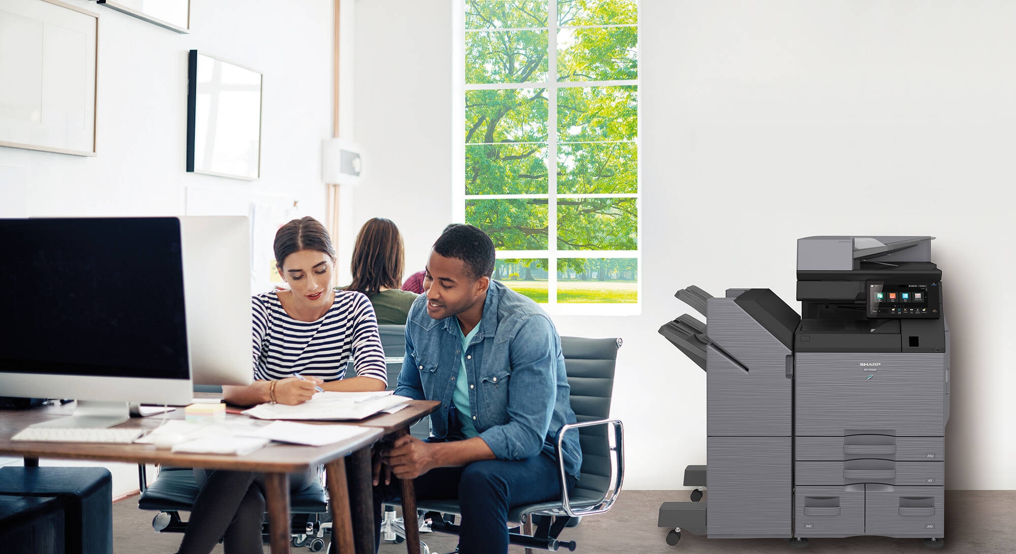 Coworkers collaborating in open office space